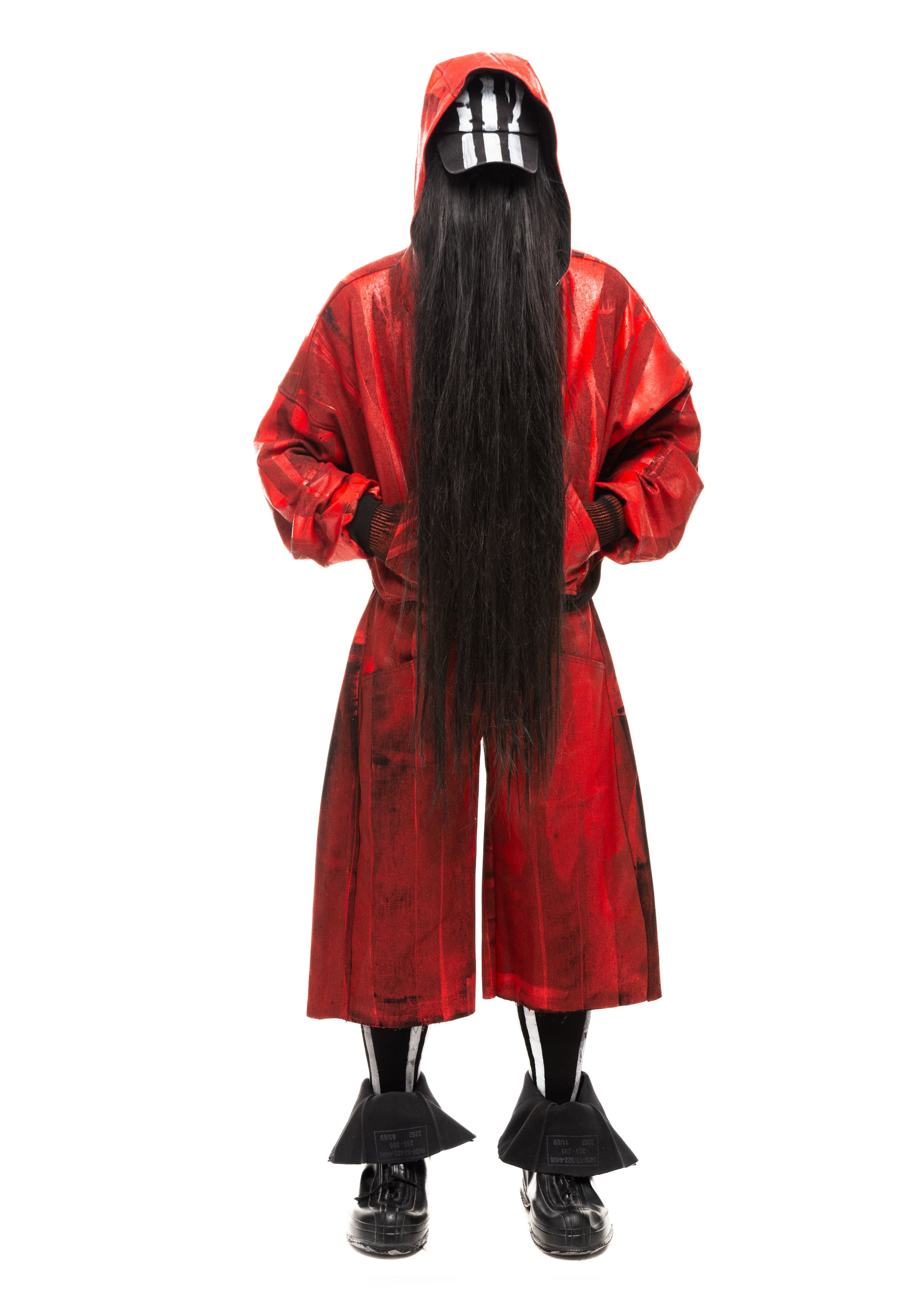 Front view of Waxed Red Denim Shorts styled with long black hair and hooded jacket