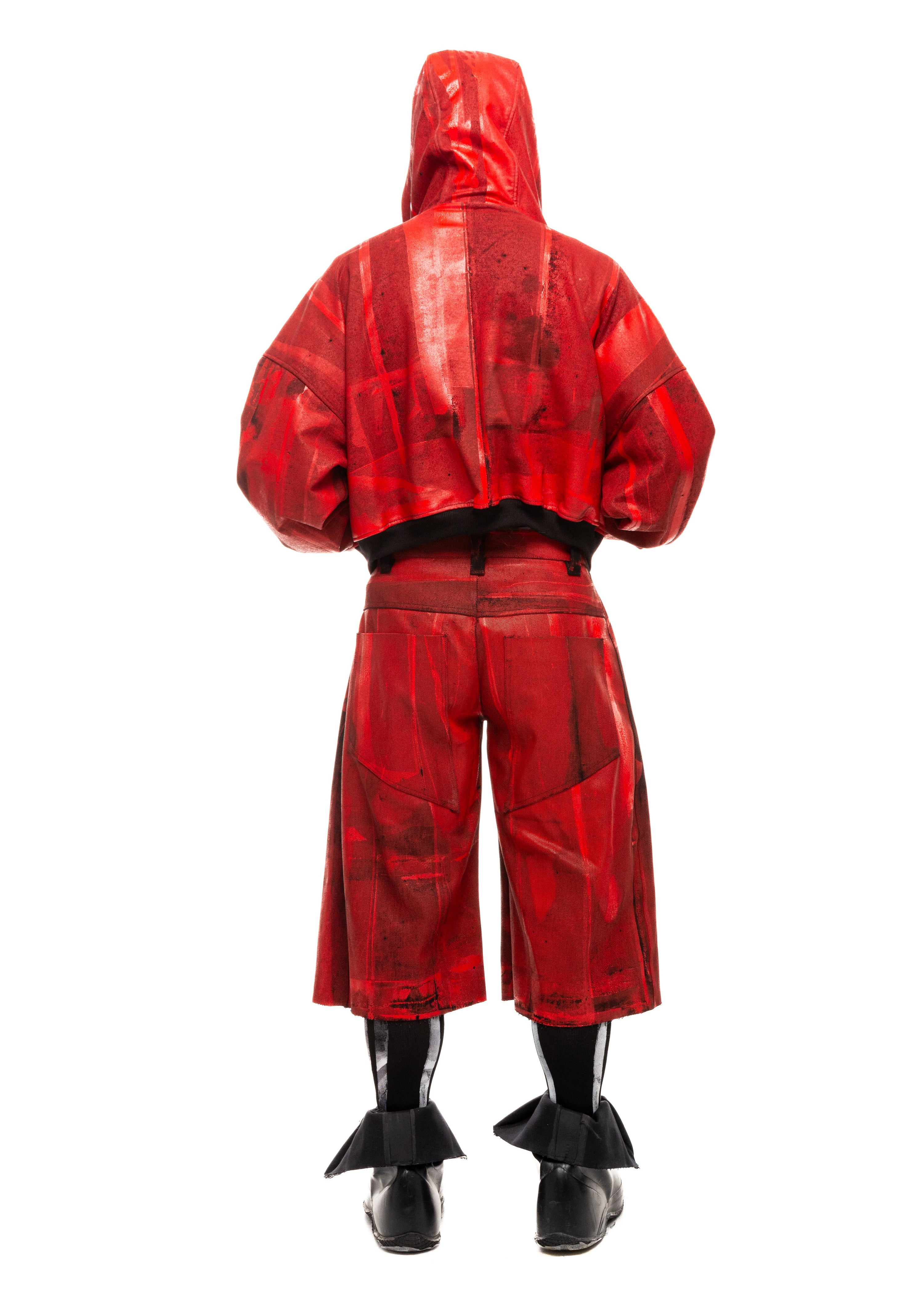Back view of Waxed Red Denim Shorts styled with long black hair and hooded jacket