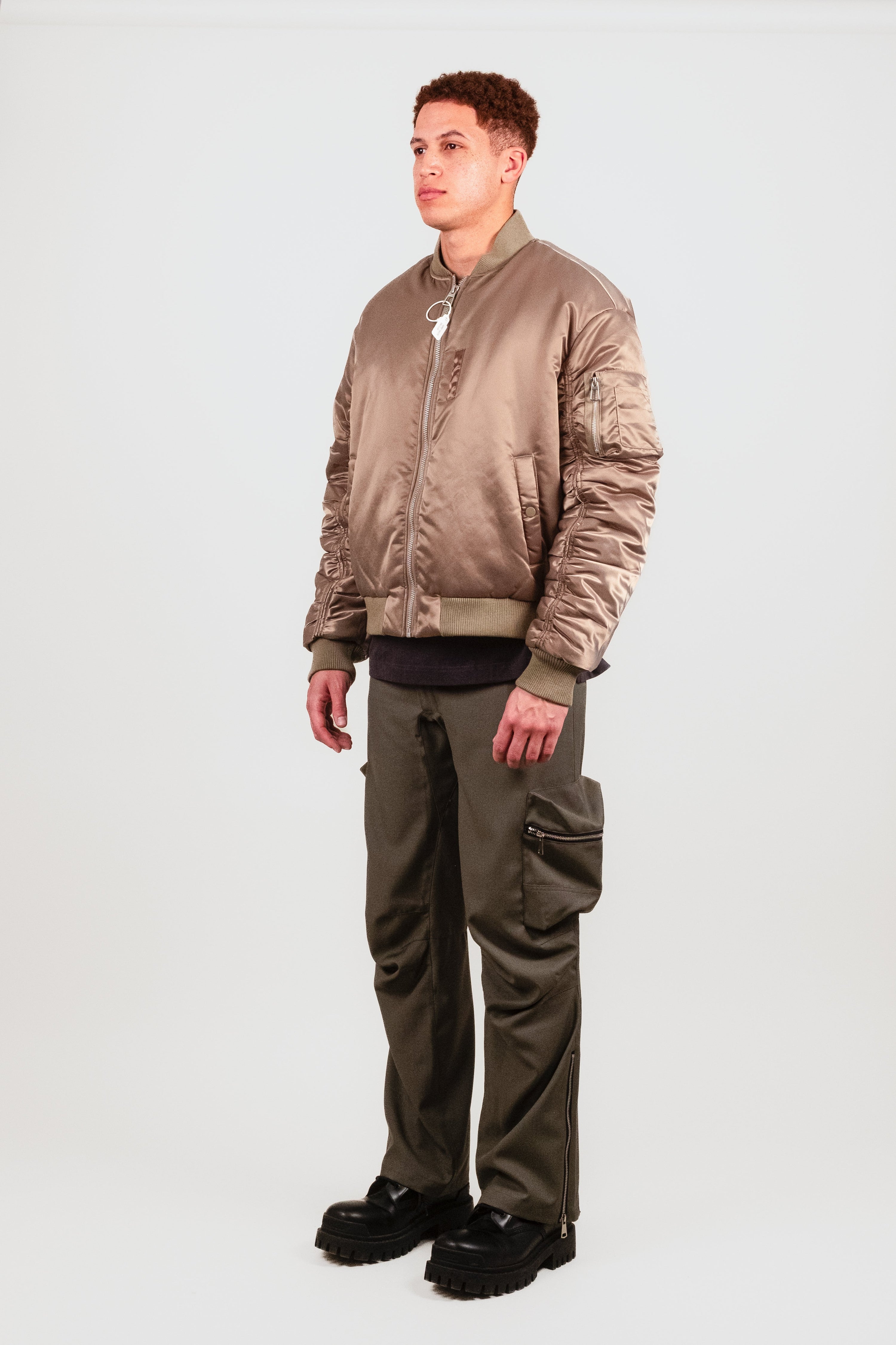Quarter angle of Nate in the Ruched Bomber — elevated MA-1 bomber with sculptural sleeve detail, side-entry pockets, and fashion-forward fit.
