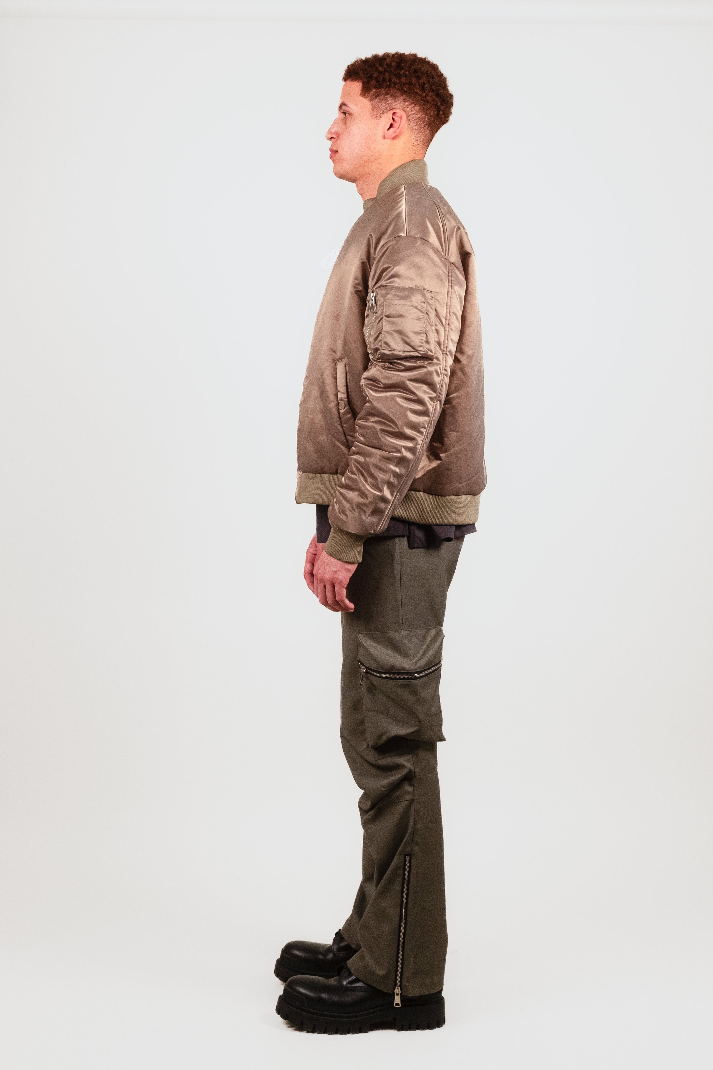 Profile of Nate in the Ruched Bomber Jacket — ruched sleeve detail accentuates the cocoon fit of this high-fashion reinterpretation of classic military outerwear.