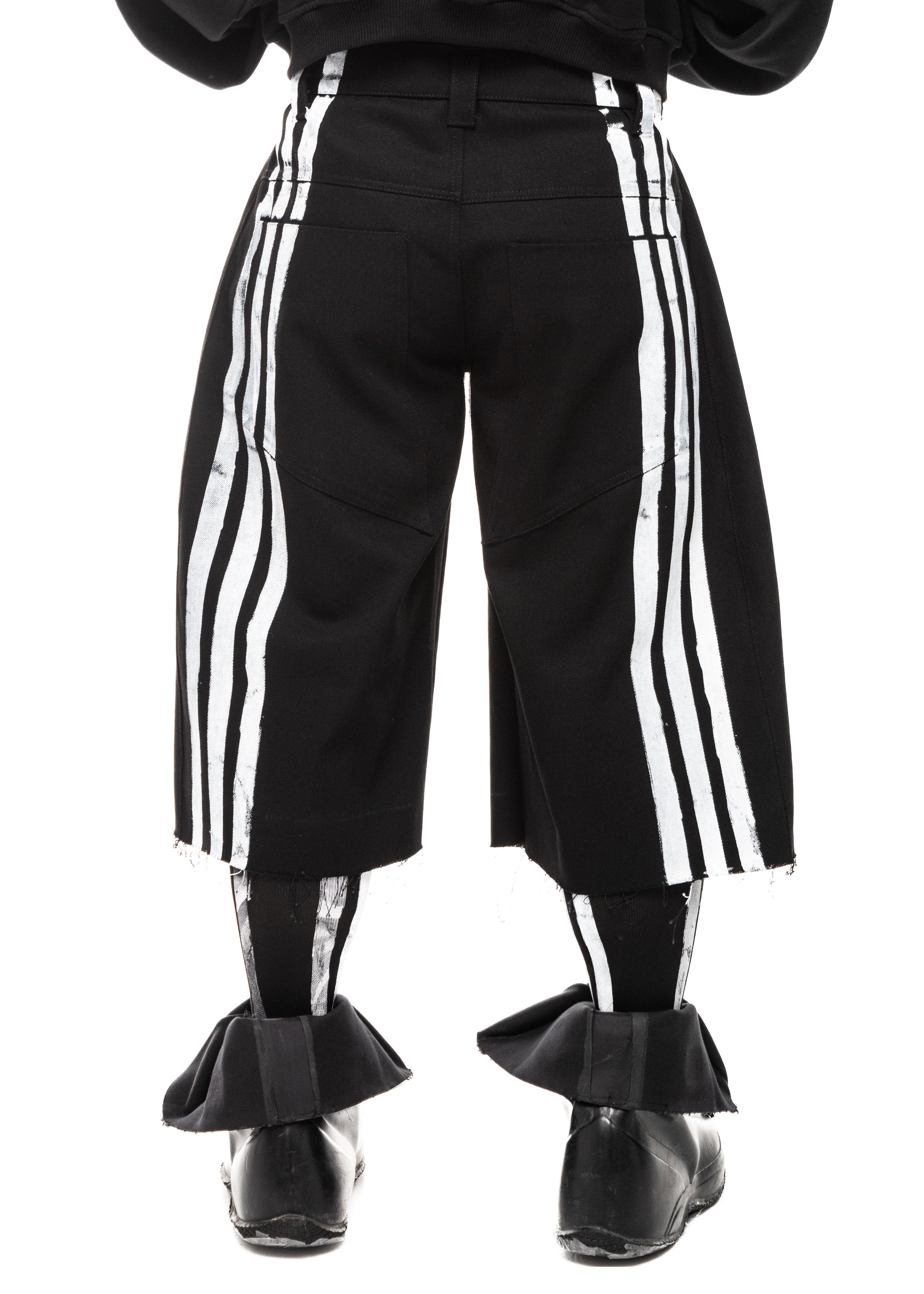 Back detail of black denim shorts featuring screen-printed white stripes and PLA4 emblem.