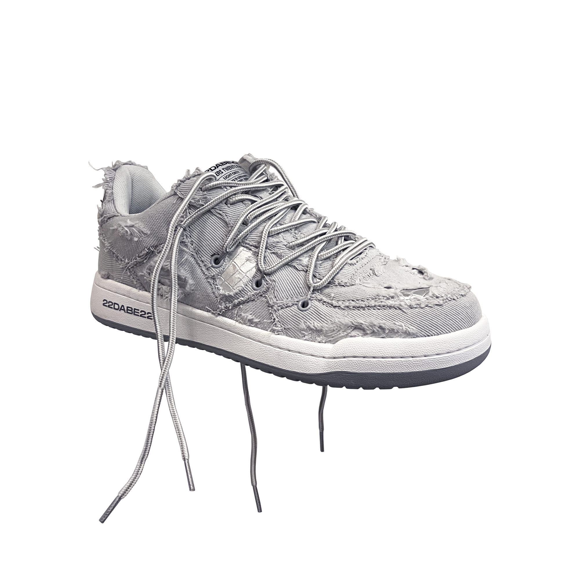 The DABE RANGER TWENTYTWO GREY shoe, a streetwear statement piece with metallic details under denim fabric on the upper. The shoe features double laces for extra style and versatility. Each shoe is handmade and unique, with every hole made by hand, giving it a one-of-a-kind look. The shoe is perfect for those who want to stand out from the crowd and make a fashion statement.